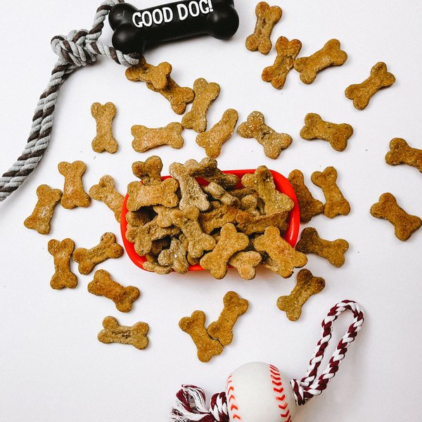 Little Feet treats scattered with dog toys